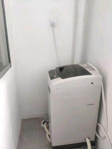 a washing machine in a corner of a room at 3 Bedroom Apartment with Pool and Beautiful View in Klebang, Ipoh in Chemor