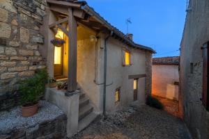 a stone house with a staircase leading to a building at Rue du Barri in Cordes-sur-Ciel