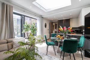 a living room with a couch and a table and chairs at Stay Mayfair in London