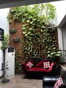 a room with a red couch in front of a brick wall at Luxury Fully furnished house for 8 people ! in Sri Jayewardenepura Kotte