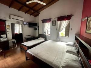 two beds in a room with two windows at Luxury Fully furnished house for 8 people ! in Sri Jayewardenepura Kotte