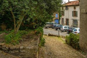 a street with cars parked in a parking lot at Rue du Barri in Cordes-sur-Ciel