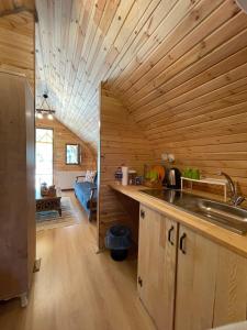 a kitchen with wooden walls and a wooden counter top at Villa Nora Butik Otel ve Bungalov in Bursa