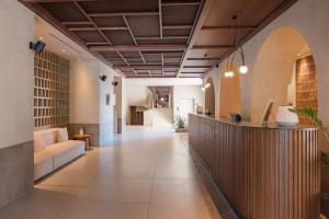 an office lobby with a reception desk and a couch at Akrotiri Beach Resort Hotel - Adult Friendly in Paleokastritsa
