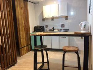 a kitchen with a counter and two stools in a room at Moderno Monoambiente con estacionamiento in Godoy Cruz