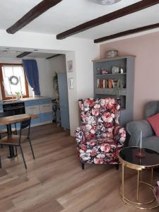a living room with a chair and a table at Ferienhaus Aschersleben in Aschersleben