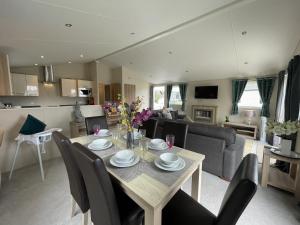 a dining room and living room with a table and chairs at 2 The Green in Tattershall