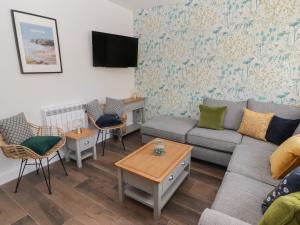 a living room with a couch and chairs at Gwynfryn in Swansea