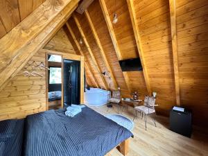 a bedroom with a bed in a wooden cabin at Thethi Villas in Theth