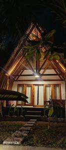 a house with a light on the front of it at Mengalung Bungalow in Kuta Lombok