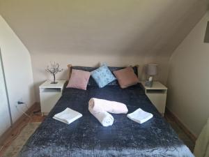 a bedroom with a bed with three pillows on it at Forest View Dunmore Galway H54P897 in Dunmore