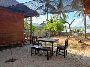 a table and two chairs and a table and a table at Yellow Coco Gili Gede in Gili Gede