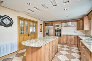a large kitchen with wooden cabinets and granite counter tops at Mountain view kingscourt 