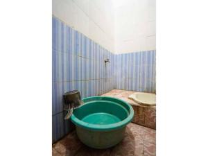 y baño con bañera y lavamanos. en OYO Life 93061 Kost Vicky Syariah en Surabaya