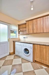 a laundry room with a washing machine in it at Mountain view kingscourt 