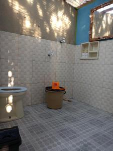a bathroom with a toilet and a sink in it at Yellow Coco Gili Gede in Gili Gede