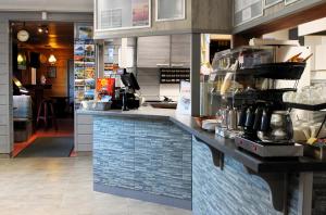a kitchen with a counter in a restaurant at Ivalo River Camping in Ivalo