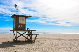 a lifeguard stand on a beach with the ocean at Newport Beach Living (1 blk to beach and 25 min to Disney) in Newport Beach