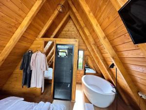 a bathroom with a tub in a wooden cabin at Thethi Villas in Theth