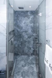 a shower with a glass door in a bathroom at Lux Studio in Downtown, 5 mins to Burj Khalifa & Dubai Mall - MAG318 in Dubai