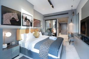 a bedroom with a large bed and a bathroom at Lux Studio in Downtown, 5 mins to Burj Khalifa & Dubai Mall - MAG318 in Dubai