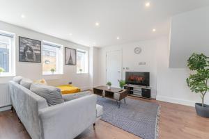 a living room with a couch and a tv at Luxury 2 Bed 2 Bath London Home - Vauxhall, Battersea & Nine Elms in London