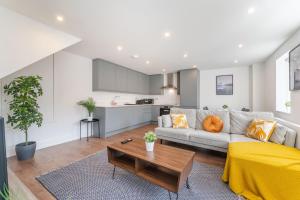 a living room with a couch and a table at Luxury 2 Bed 2 Bath London Home - Vauxhall, Battersea & Nine Elms in London