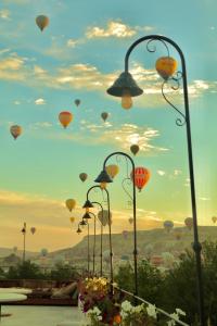 a group of hot air balloons flying in the sky at A la mode Cappadocia in Goreme