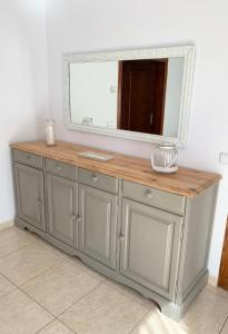 a mirror on top of a dresser in a room at Cal Jan - El Monterròs in Bellver de Cerdanya