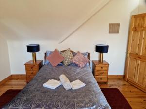 a bedroom with a bed with two towels on it at Forest View Dunmore Galway H54P897 in Dunmore