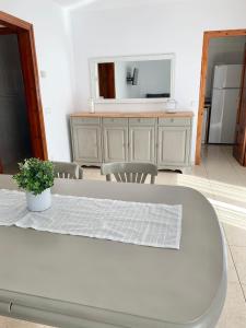 a white table and chairs in a room with a mirror at Cal Jan - El Monterròs in Bellver de Cerdanya