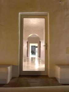 a hallway with a mirror in a building at uma casa em entradas guesthouse in Entradas