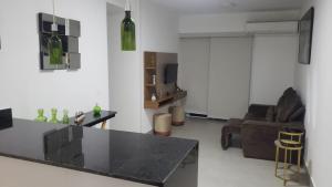 a living room with a black counter and a couch at Apartamento Olof in Rio de Janeiro