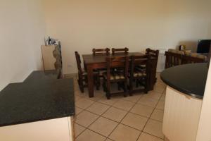 a kitchen and dining room with a table and chairs at Strandloper 3 in Margate