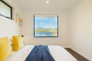 a bedroom with a bed and a window at Hobart 4-bedroom Spacious Waterfront House in Hobart