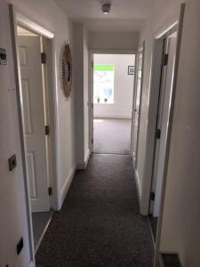 an empty hallway with two doors and a hallwayngth at Central Morecambe, minimalist seaside flat N.1 in Morecambe