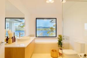 a bathroom with a sink and a window at Hobart 4-bedroom Spacious Waterfront House in Hobart