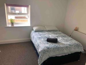 a bedroom with a bed with a pillow on it at Central Morecambe, minimalist seaside flat N.1 in Morecambe