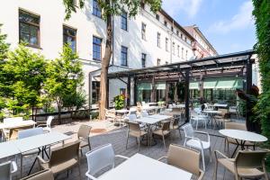 an outdoor patio with tables and chairs at City Hotels Algirdas in Vilnius