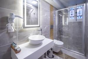 a bathroom with a sink and a shower and a toilet at Best Pasaport Pier Otel Kadıköy in Istanbul