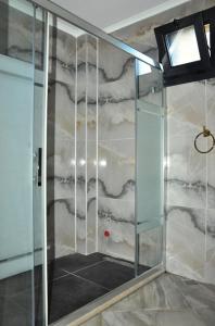 a shower with a glass door in a bathroom at Villa Sultan,s Palace in Fethiye