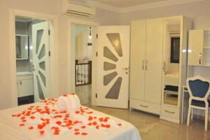 a bedroom with a bed with red flowers on it at Villa Sultan,s Palace in Fethiye