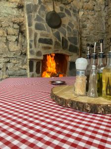 a table with a fireplace and a table with a table cloth at Guest House BOZVILL in Bozovec