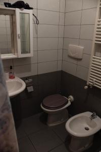 a bathroom with a toilet and a sink at Red House Tiburtina in Rome
