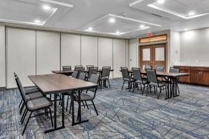 a conference room with tables and chairs and a whiteboard at Holiday Inn Express Hotel & Suites El Centro, an IHG Hotel in El Centro