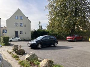 a car parked in a parking lot in front of a house at Three Bedroom Apartment In Kolding, Udsigten 4, in Kolding