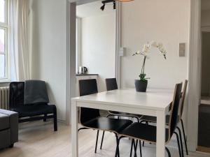 a dining room with a white table and chairs at Three Bedroom Apartment In Kolding, Udsigten 4, in Kolding