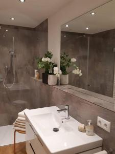 a bathroom with a sink and a mirror at Wohnung im Herzen der Altstadt in Schwaz