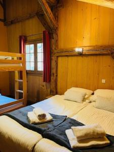 a bedroom with two beds and a bunk bed at Chalet Les Lanchettes in Morzine