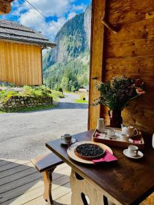 a wooden table with a plate of food on it at Chalet Les Lanchettes in Morzine